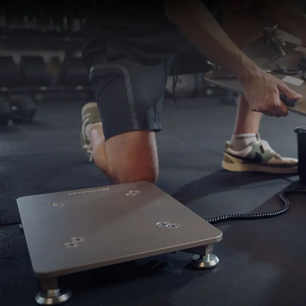A PlateMate force plate on the floor of a gym, being set up for a test